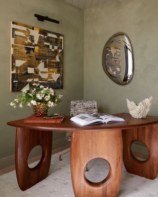 A study room with khaki walls and wooden furniture