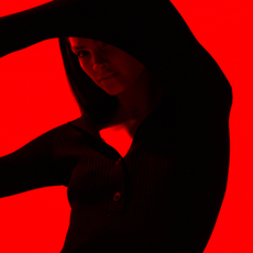 Model on a red background wearing Reiss clothing