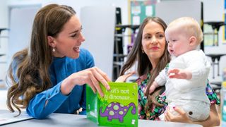 Britain's Catherine, Duchess of Cambridge (L) meets Laura Molloy and her 10-month-old son Saul Molloy during a visit to St. John's Primary School in Glasgow on May 11, 2022
