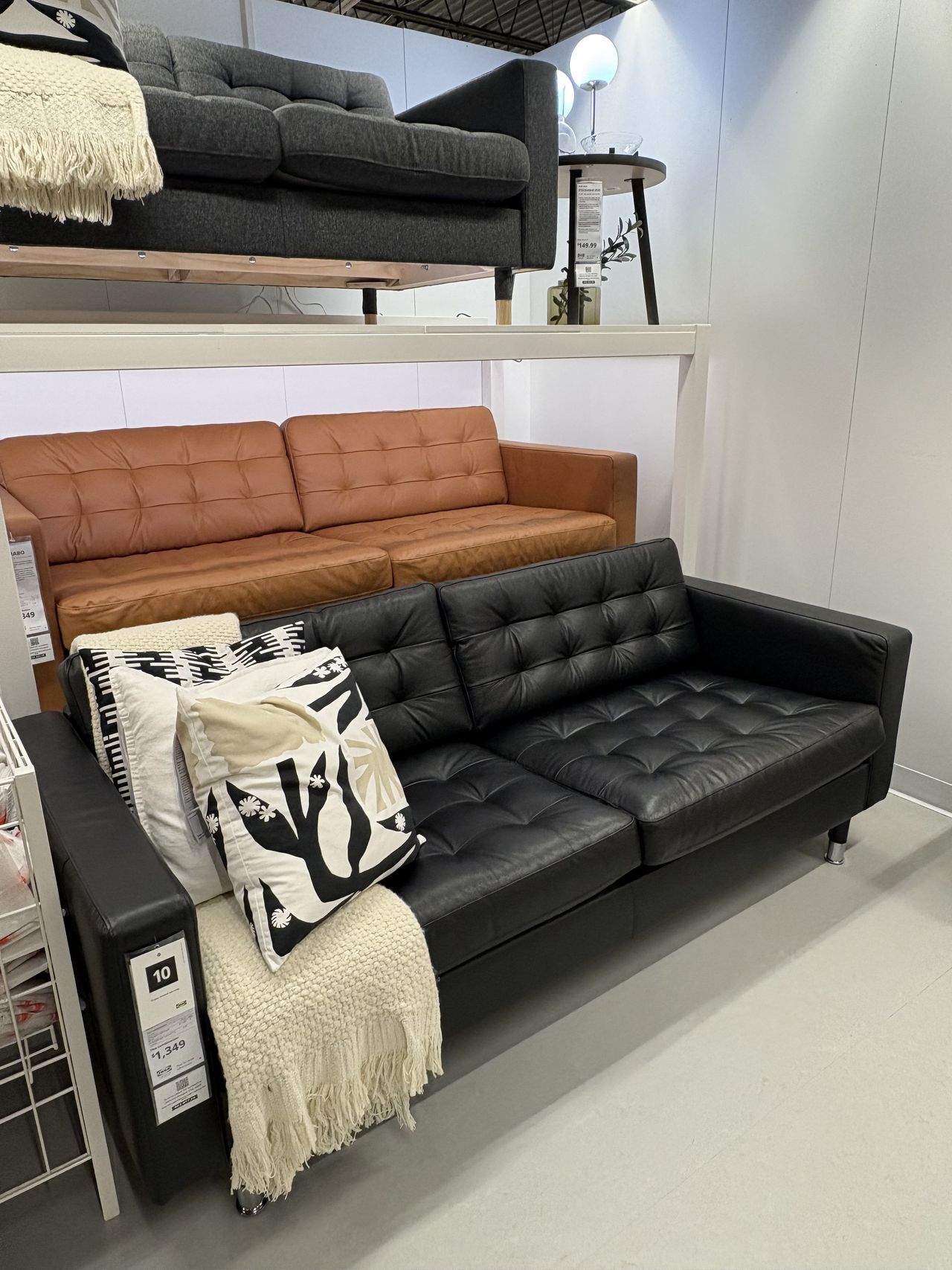 a black leather sofa in an IKEA showroom.