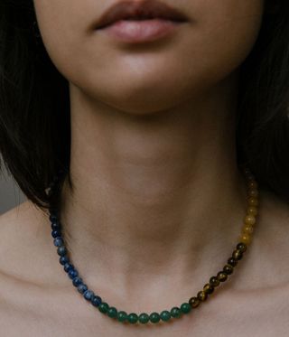 Beaded necklace worn by a model in different colours