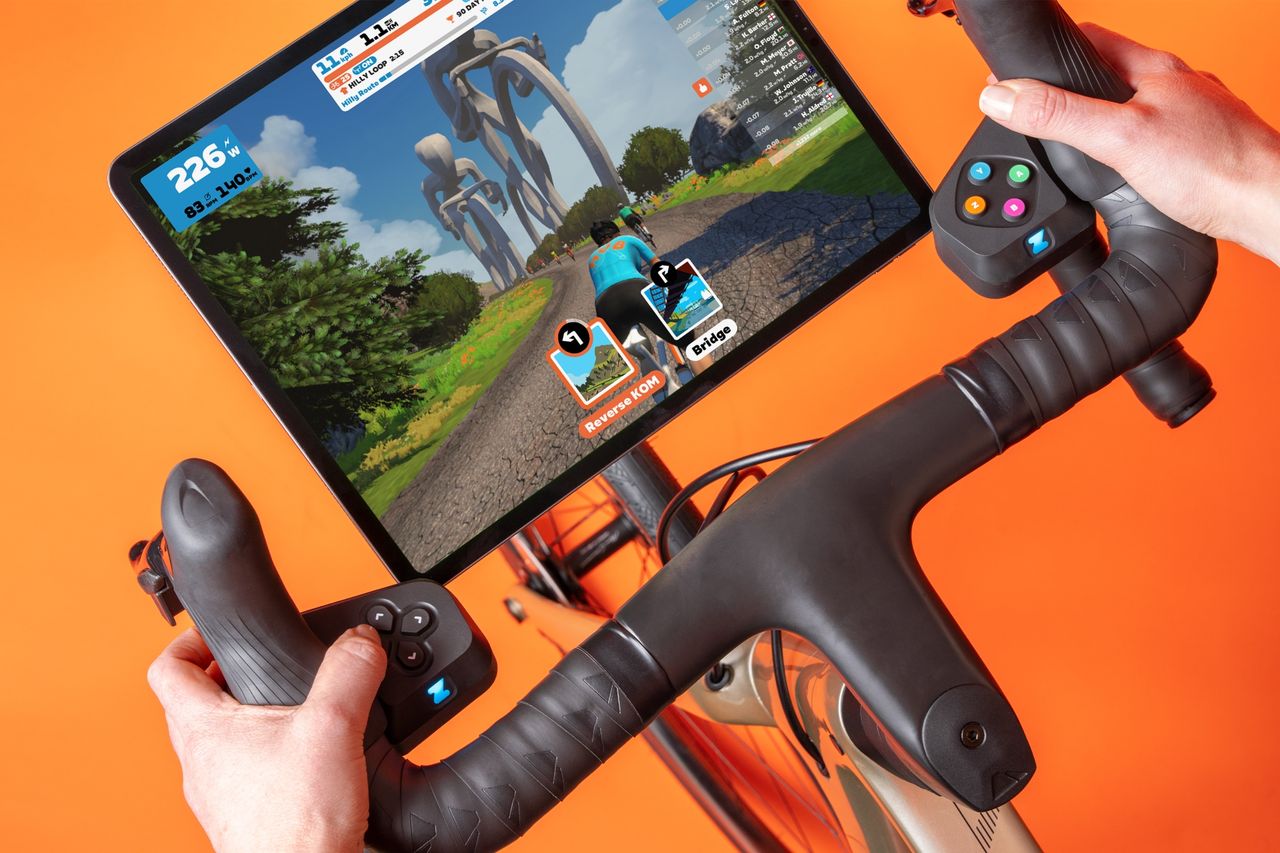 Zwift Play Controllers fitted on bike and showing Zwift game play in iPad