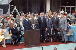 On a stage outside Building 1 at the Manned Spacecraft Center in Houston, President Richard M. Nixon introduces Sigurd Sjoberg (right), the Director of Flight Operations at the Manned Spacecraft Center, and the four Apollo 13 flight directors — from left, Glynn Lunney, Gene Kranz, Gerald Griffin and Milton Windler. The team received the highest civilian honor, the Presidential Medal of Freedom.
