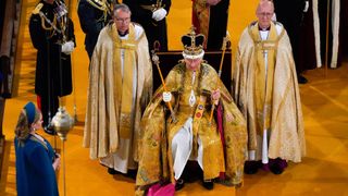 TOPSHOT - Britain's King Charles III, wearing the St Edward's Crown and holding the Sovereign's Sceptre with Dove (R) and Sovereign's Sceptre with Cross, during the Coronation Ceremony inside Westminster Abbey in central London on May 6, 2023. The set-piece coronation is the first in Britain in 70 years, and only the second in history to be televised. Charles will be the 40th reigning monarch to be crowned at the central London church since King William I in 1066. Outside the UK, he is also king of 14 other Commonwealth countries, including Australia, Canada and New Zealand. Camilla, his second wife, will be crowned queen alongside him and be known as Queen Camilla after the ceremony. (Photo by Andrew Matthews / POOL / AFP)
