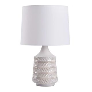 A white ceramic table lamp with a white lampshade