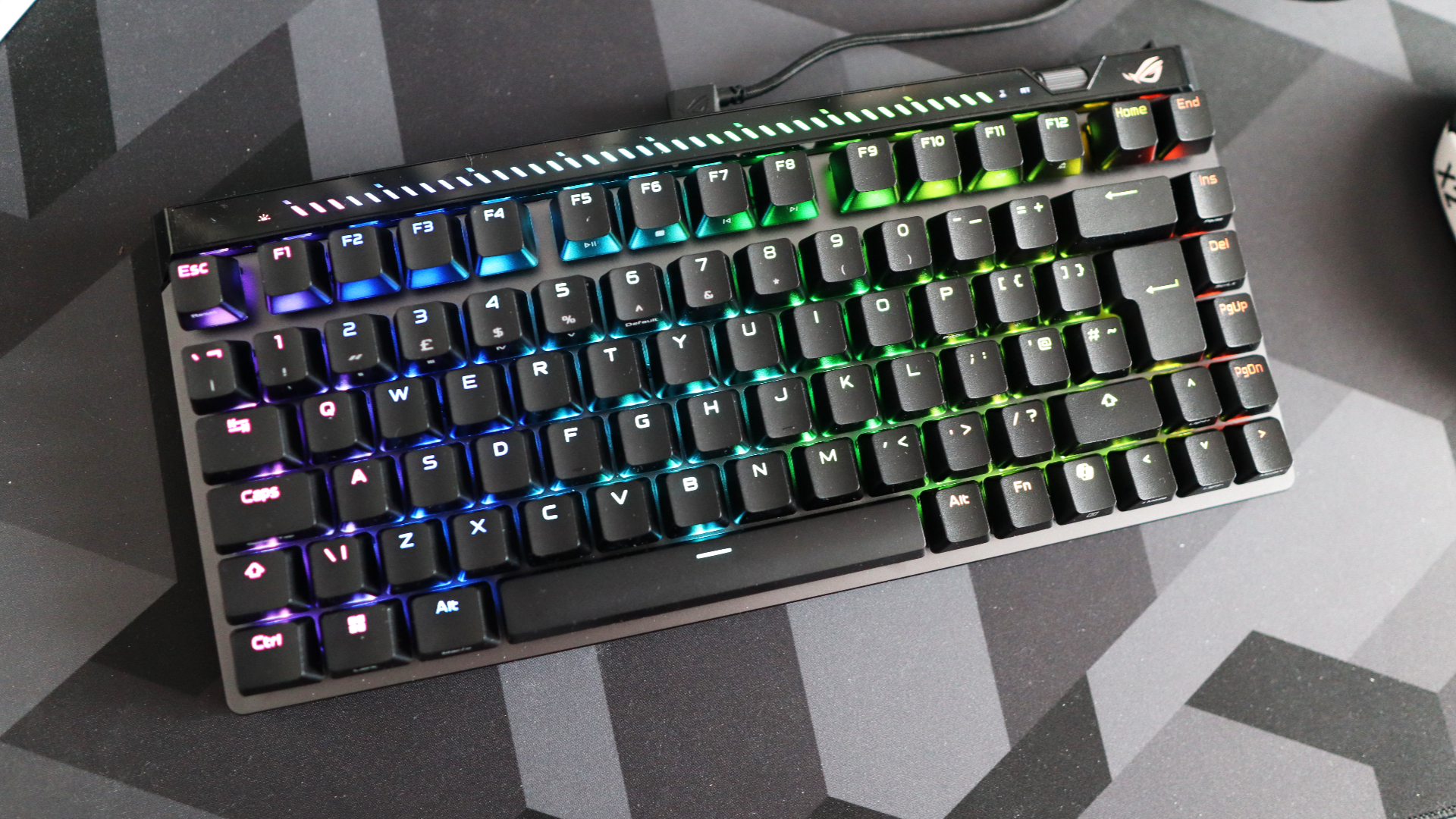 The Asus ROG Falchion Ace 75 HE on a desk with the lighting enabled.