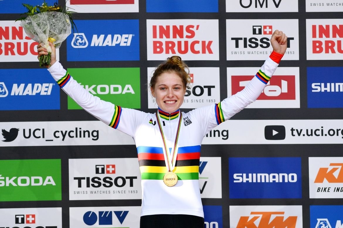 Laura Stigger pulls on the rainbow jersey