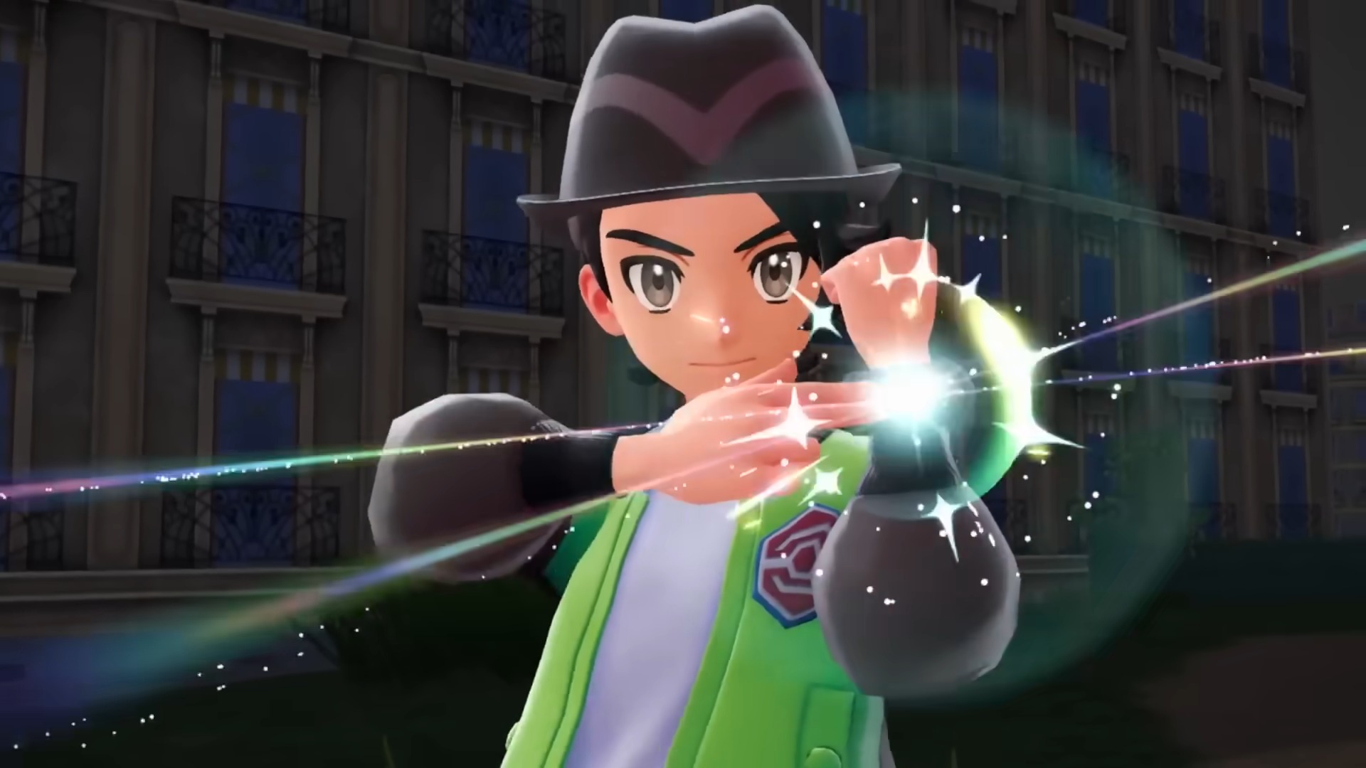 A trainer in a green uniform touches a glowing bracelet