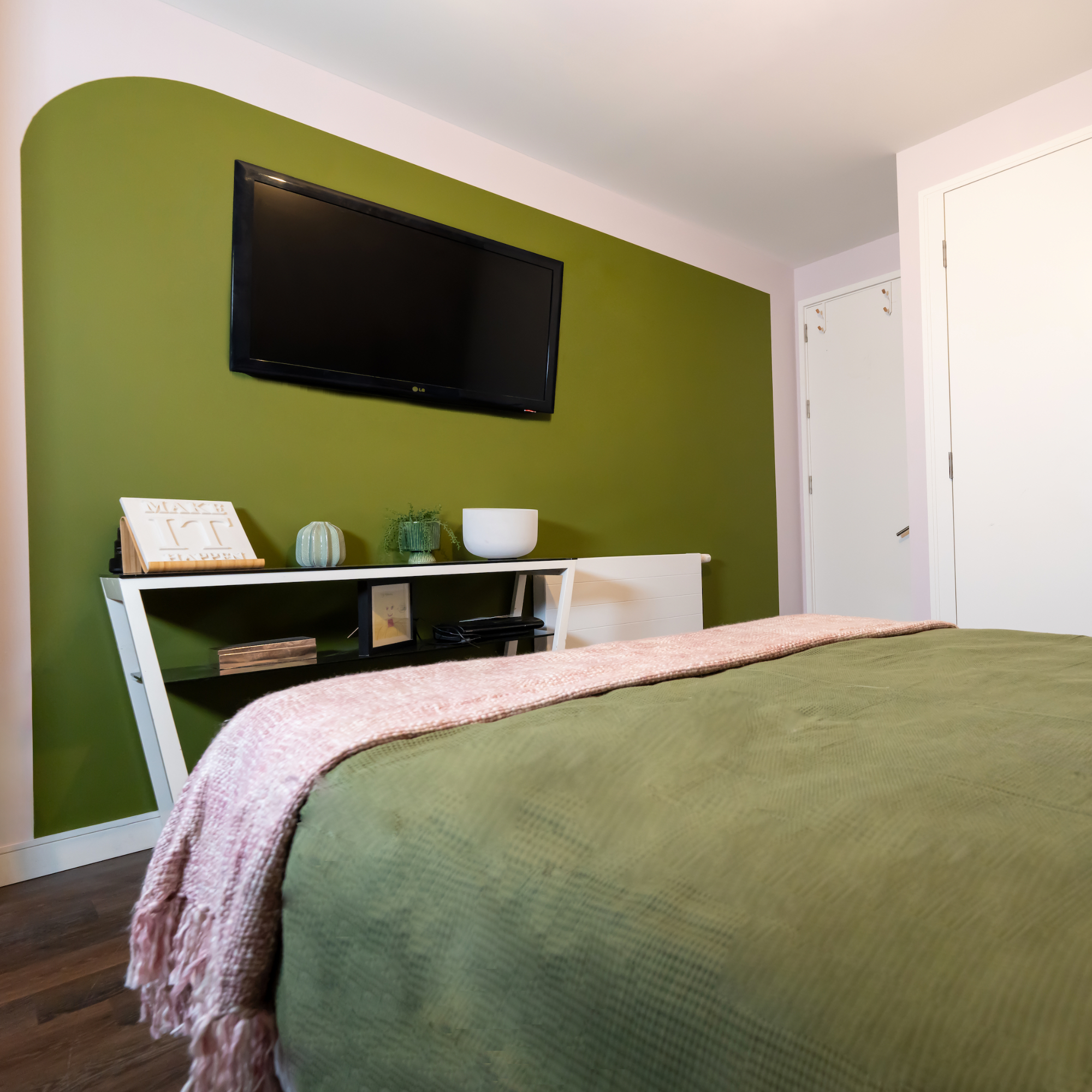 green bedroom wall with tv