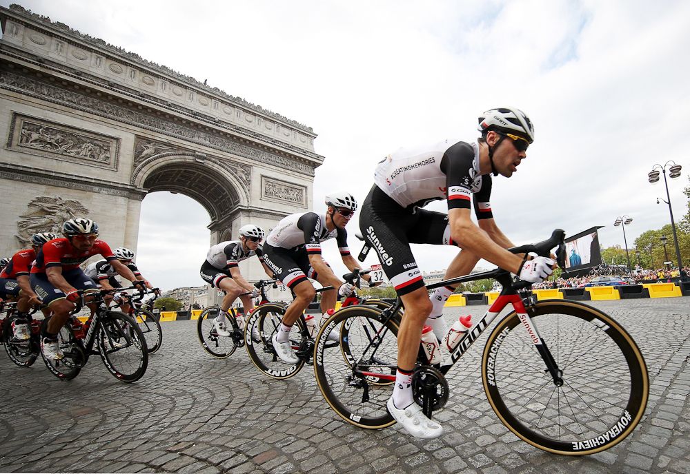 Team Sunweb's Tom Dumoulin, Edward Theuns and Chad Haga ride in front of the Arc de Triomphe during the final stage of the 2018 Tour de France