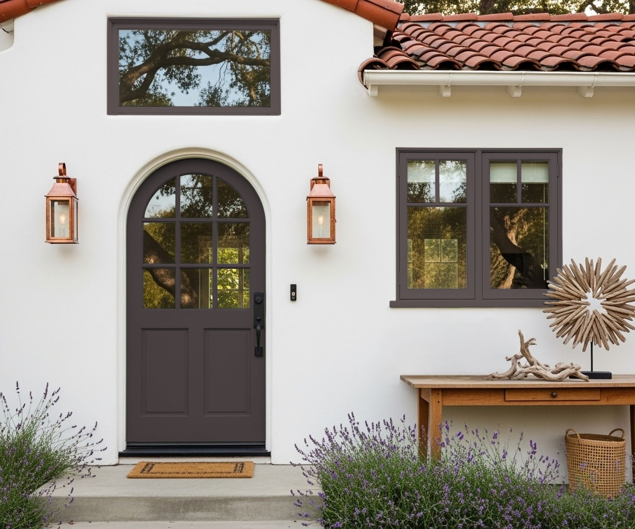 Tuscan style home with terracotta slated roof, white exterior, and windows and curved door painted in French Press Coffee by Dunn-Edwards.
