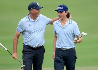 Matt Kuchar of The United States embraces his son Cameron Kuchar on the ninth green (their final hole) after they had posted a round of 57, 15 under par total during the first round of the PNC Championship