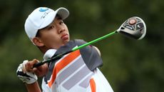 Guan Tianlang hits a shot during the 2013 Masters