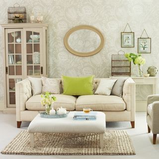 white living room with wallpaper and sofa