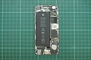 Close up view of Apple iPhone internal parts, compartment and battery. iPhone tear down.