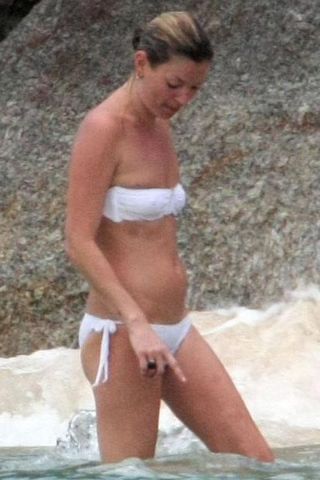 Kate Moss Shows Off A Flawless Tan In A Bright White Bikini