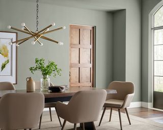 dining room with light sage green walls and modern decor