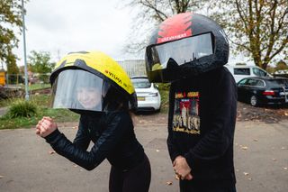 Honor Elliott wearing a papier-mâché version of the Giro Aerohead II