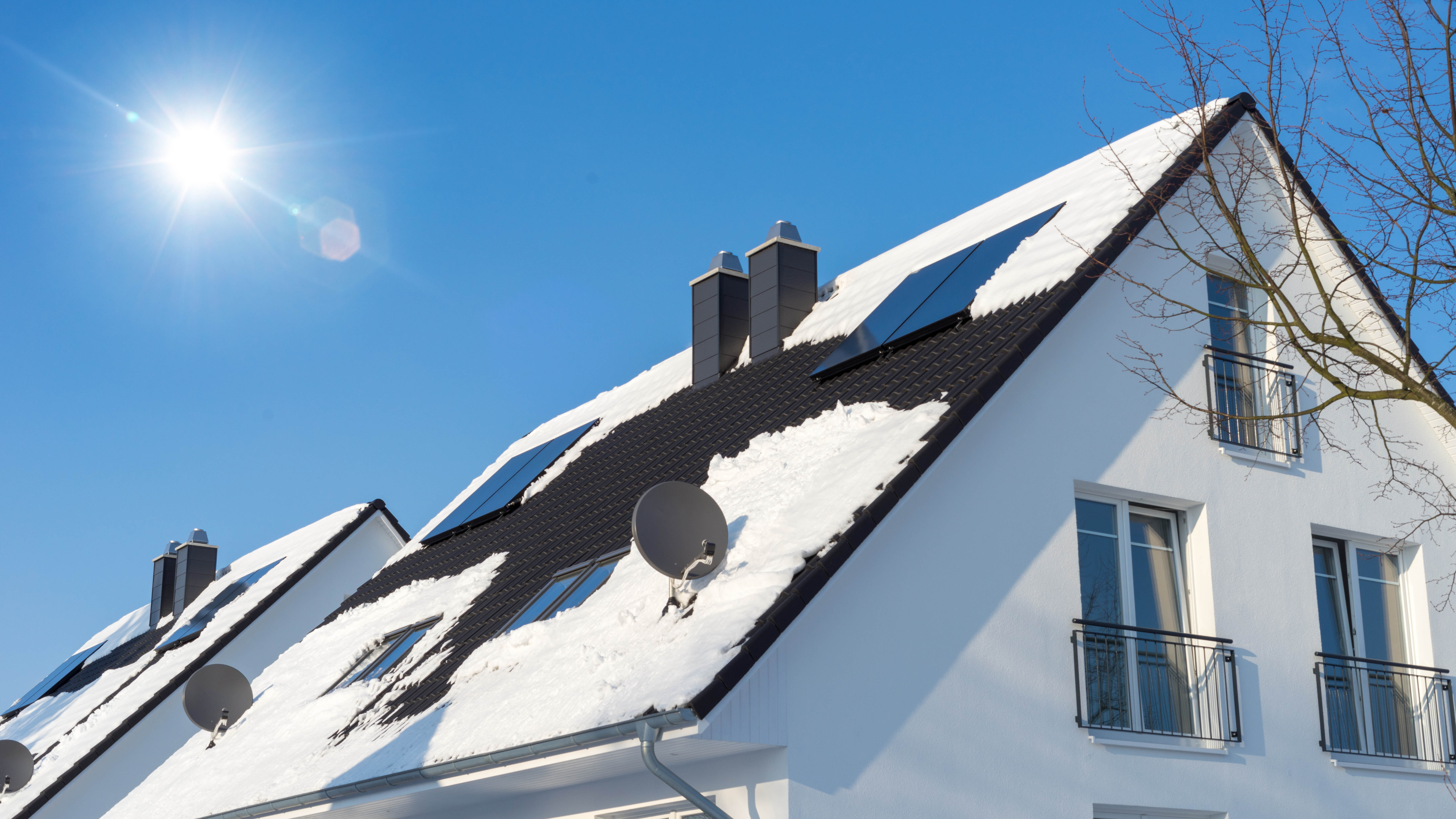 Roof with solar panels covered in snow