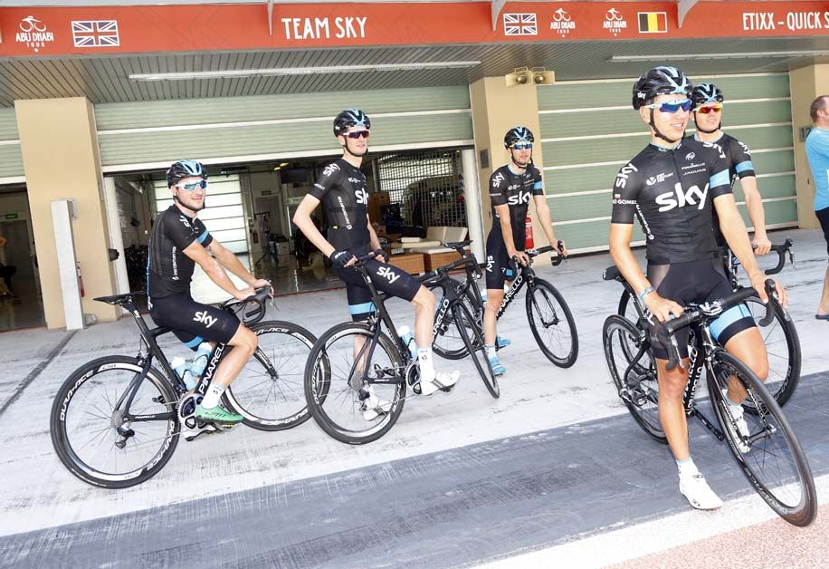 Team Sky wait outside their pit box on the Yas Marina track