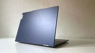 The Lenovo IdeaPad 5 2-in-1 with lid open seen from the back on a white table