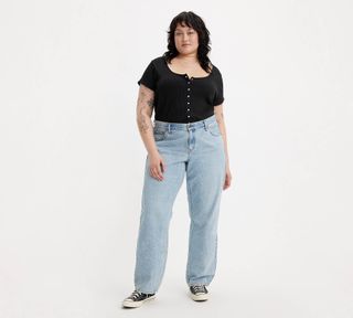 Levi's model in wide leg jeans, black t-shirt, and converse