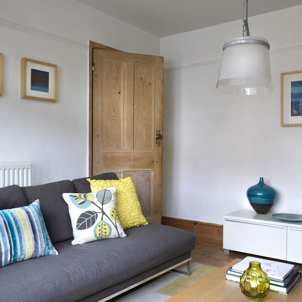 white living room with grey sofa cream wooden coffee table