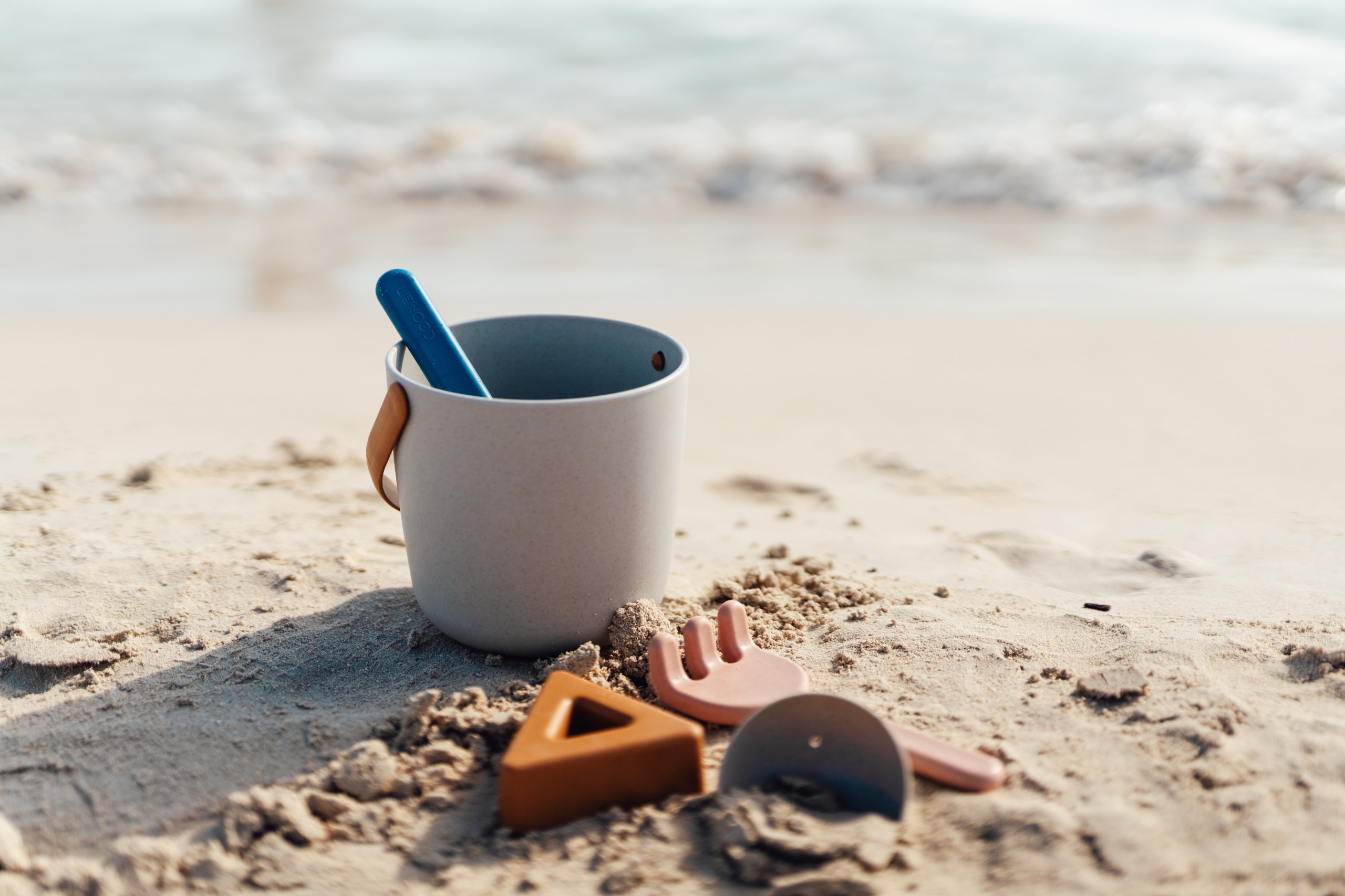 a Bucket and spade on a sandy beach