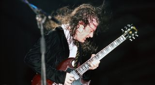 Angus Young performs with AC/DC at the Forum in Inglewood, California in 1985