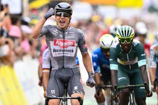 Alpecin-Deceuninck team's Belgian rider Jasper Philipsen cycles to the finish line to win ahead of second-placed Intermarche - Wanty team's Eritrean rider Biniam Girmay (R) during the 10th stage of the 111th edition of the Tour de France cycling race, 187,3 km between Orleans and Saint-Amand-Montrond, central France, on July 9, 2024. (Photo by Marco BERTORELLO / AFP)