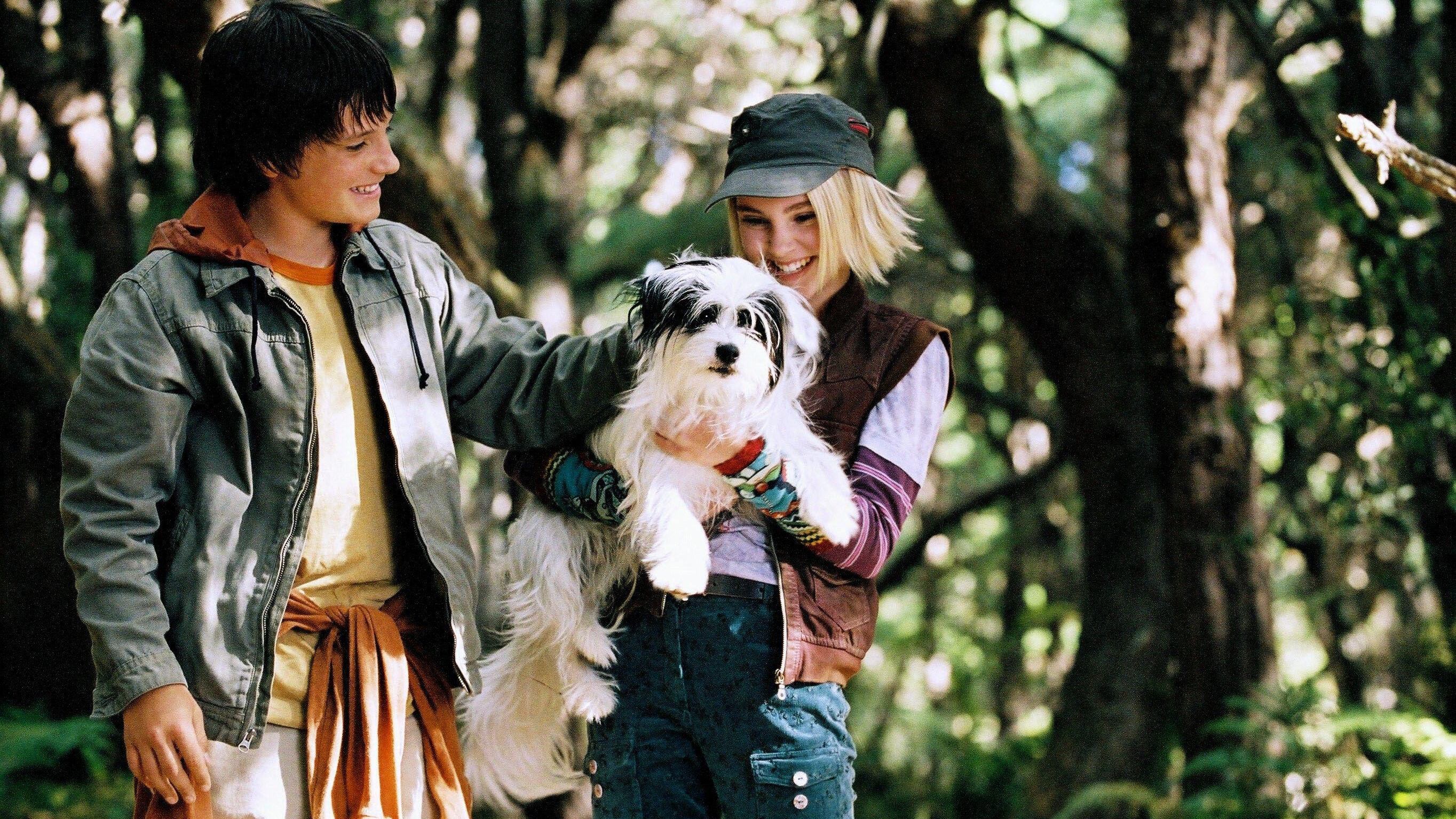 L-R: Jess (Josh Hutcherson) and Leslie (AnnSophia Ribb) holding their dog P.T. in a scene from "Bridge to Terabithia"