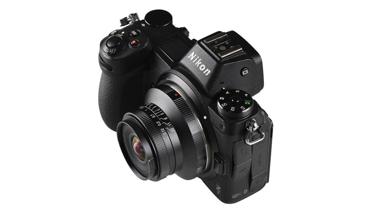 Laowa 15mm f/5 Cookie FF lens, mounted to a camera, against a white background