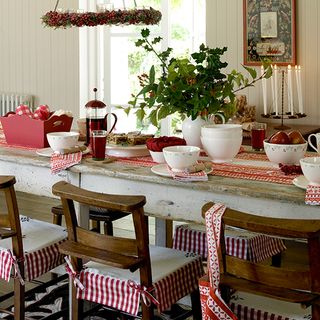 christmas dining room with red check chair covers and table runner