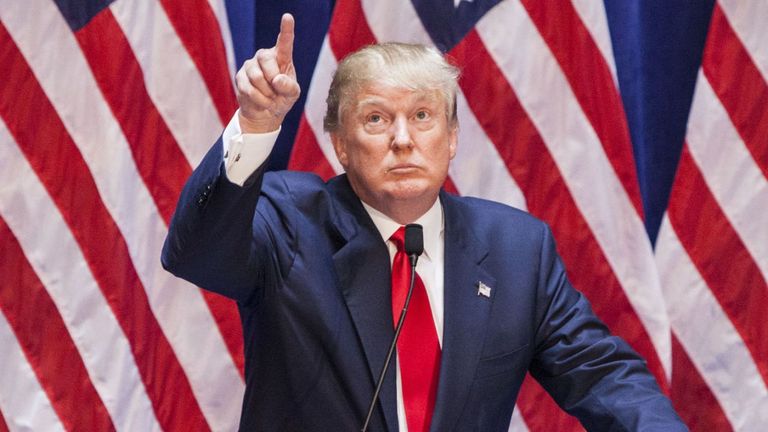 Flag of the united states, Flag, Microphone, Government, Podium, Public speaking, Stage equipment, Dress shirt, Lectern, Gesture,