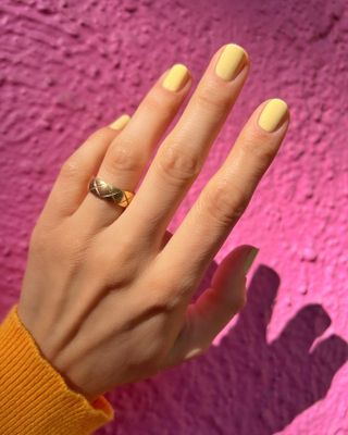 Butter yellow nail polish on short nails
