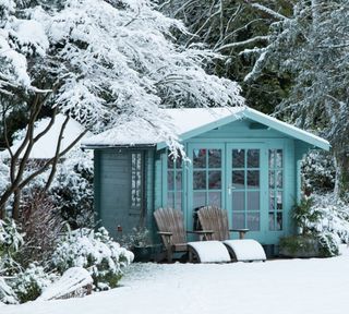 blue summer house in winter