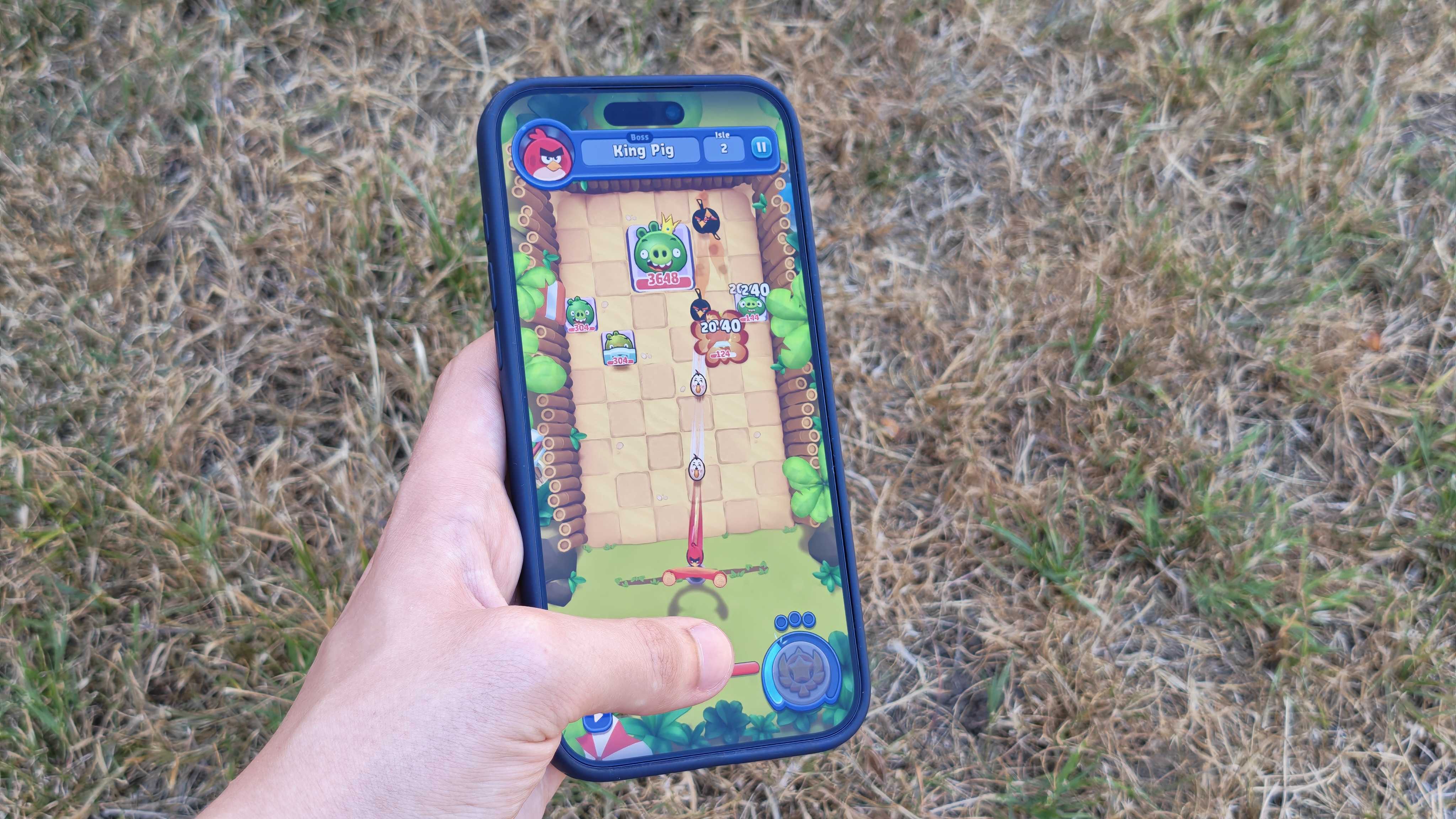 Apple Arcade being used on an iPhone 17 Pro Max in a grassy outdoor space.