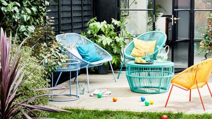 A contemporary brightly coloured outdoor lounge set on a decked patio