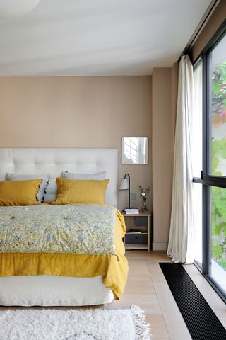 Beige bedroom with yellow bedding