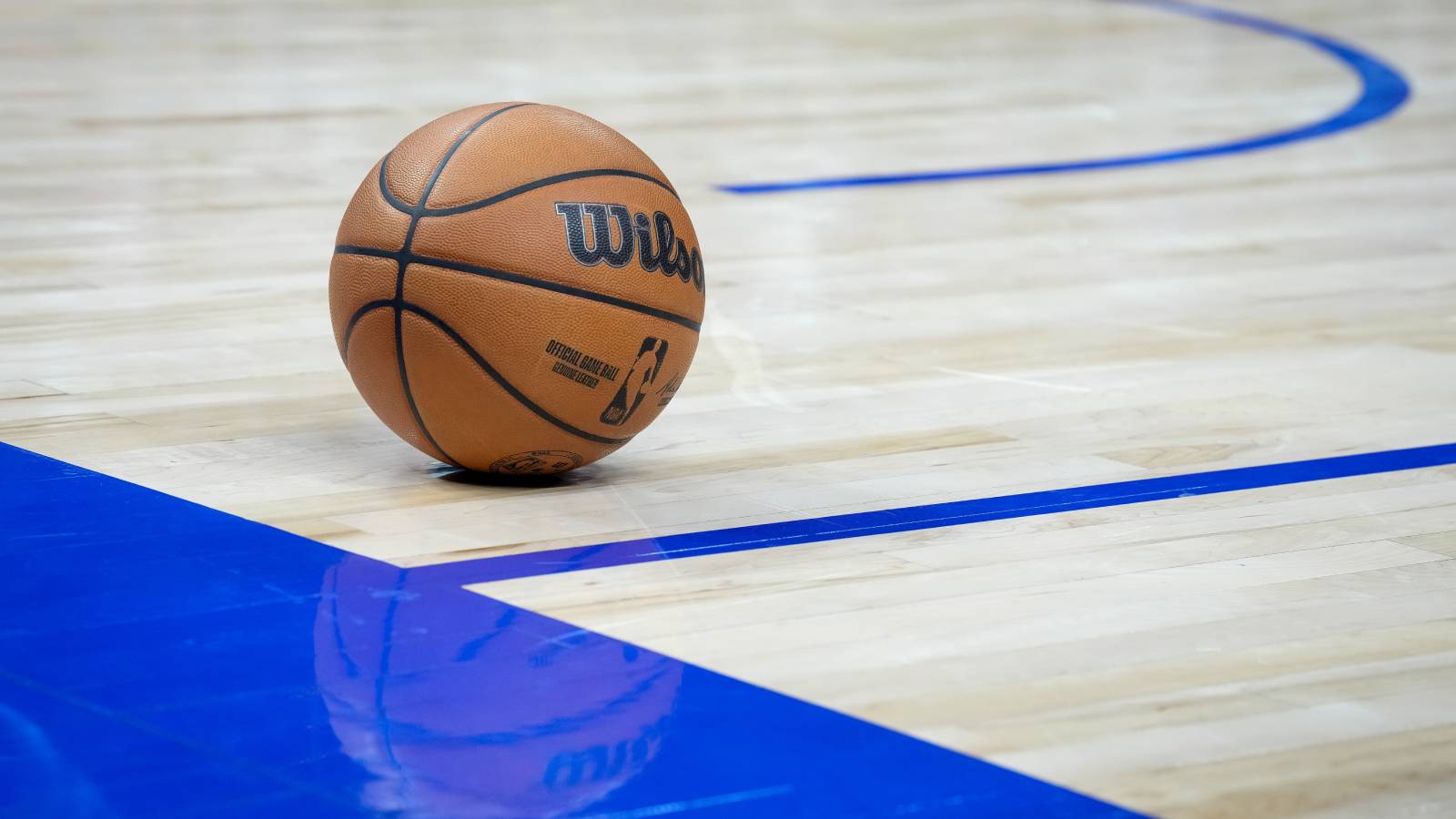 A picture of a basketball on a court, from a 2023 NBA game between New Orleans Pelicans and Detroit Pistons.