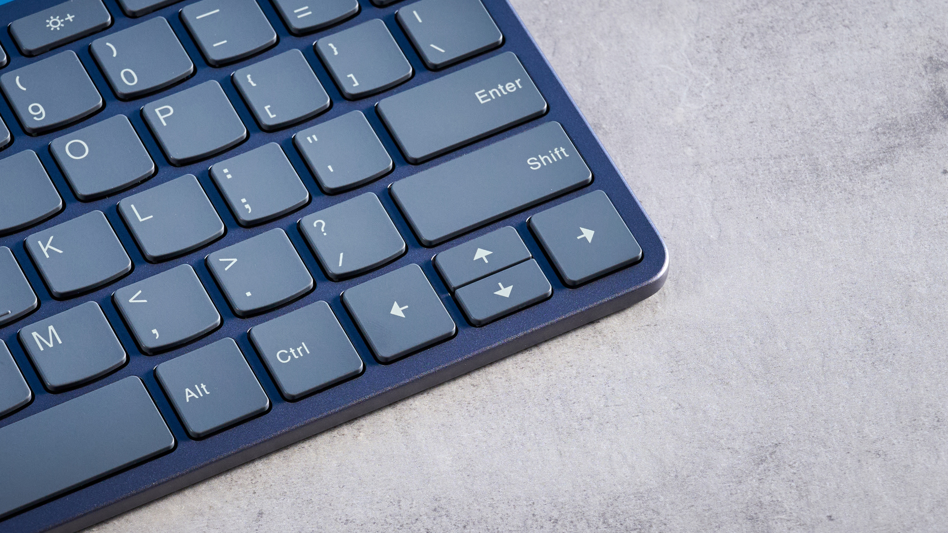 Lenovo Multi Device Keyboard photographed in front of a blue background.