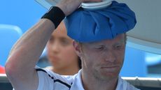 Dmitry Tursunov of Russia cools off during a break in his men's singles match against Uzbekistan's Denis Istomin on day three of the 2014 Australian Open tennis tournament in Melbourne on Jan