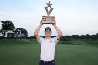 Tim Widing holds a trophy above his head