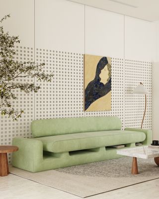 A pale green sofa works with light yellow artwork in this pared back scheme