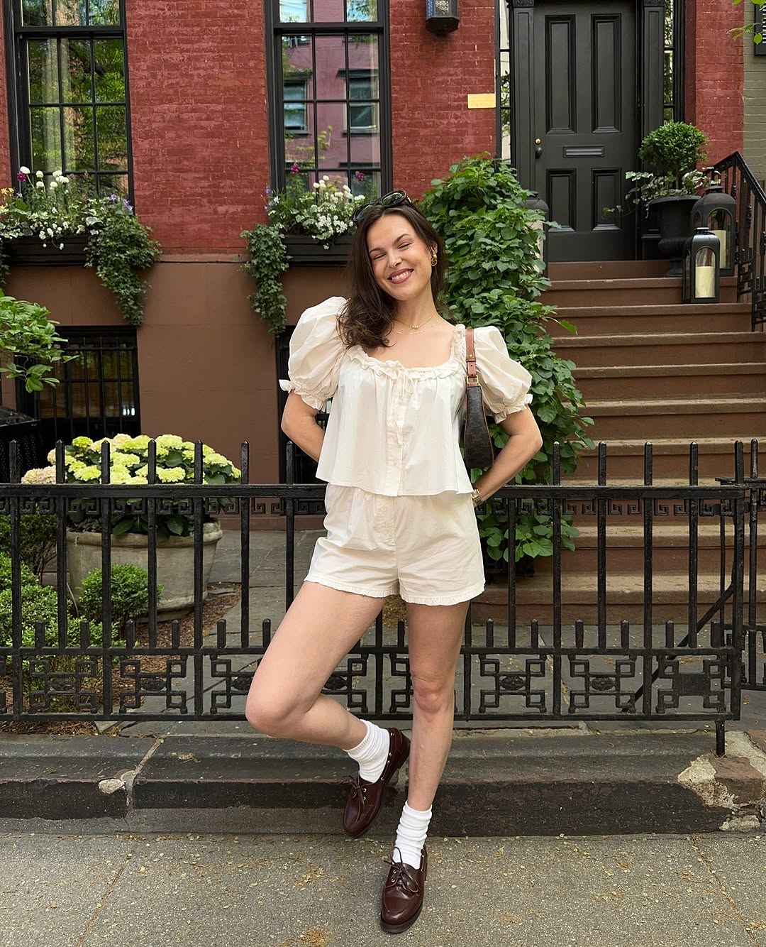 woman wearing white breezy shorts with matching eyelet top and loafers