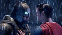 Ben Affleck as Batman and Henry Cavill as Superman standing in the rain during the DC movie Batman v Superman: Dawn of Justice.