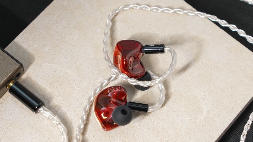 A pair of earbuds from the Zeitgeist Trees collection plugged into a music player.