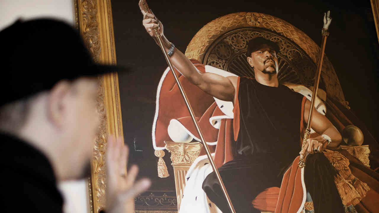 Ice T posing for a photograph at home iin front of a painting