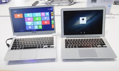 An ultra thin Samsung Notebook Series 9 laptop computer, left, runnung Microsoft Windows 8 sits next to an Apple Macbook Air.