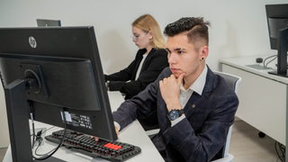 Students in front of computer in classroom
